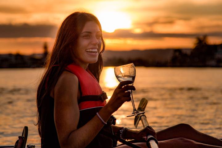 Woman drinks wine on kayak