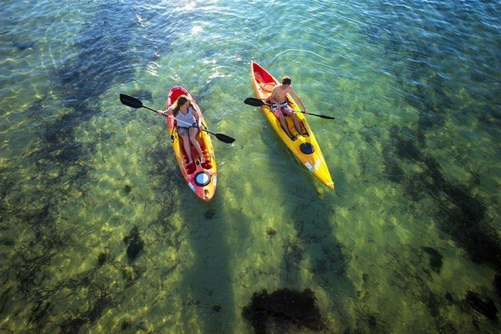 a person riding a surf board on a body of water