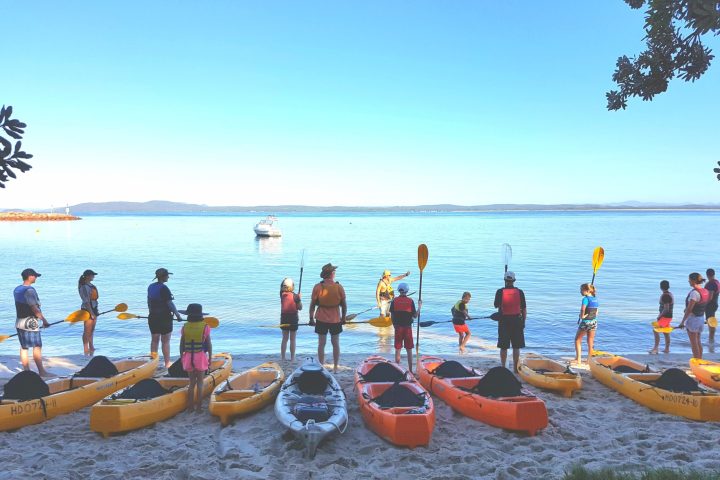a group of people in a boat on a body of water