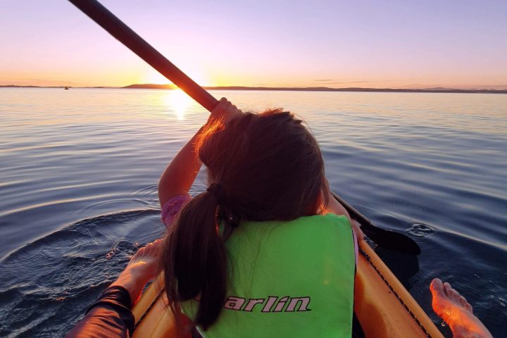 a person sitting on a boat in a body of water