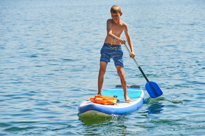 a person riding a surf board on a body of water